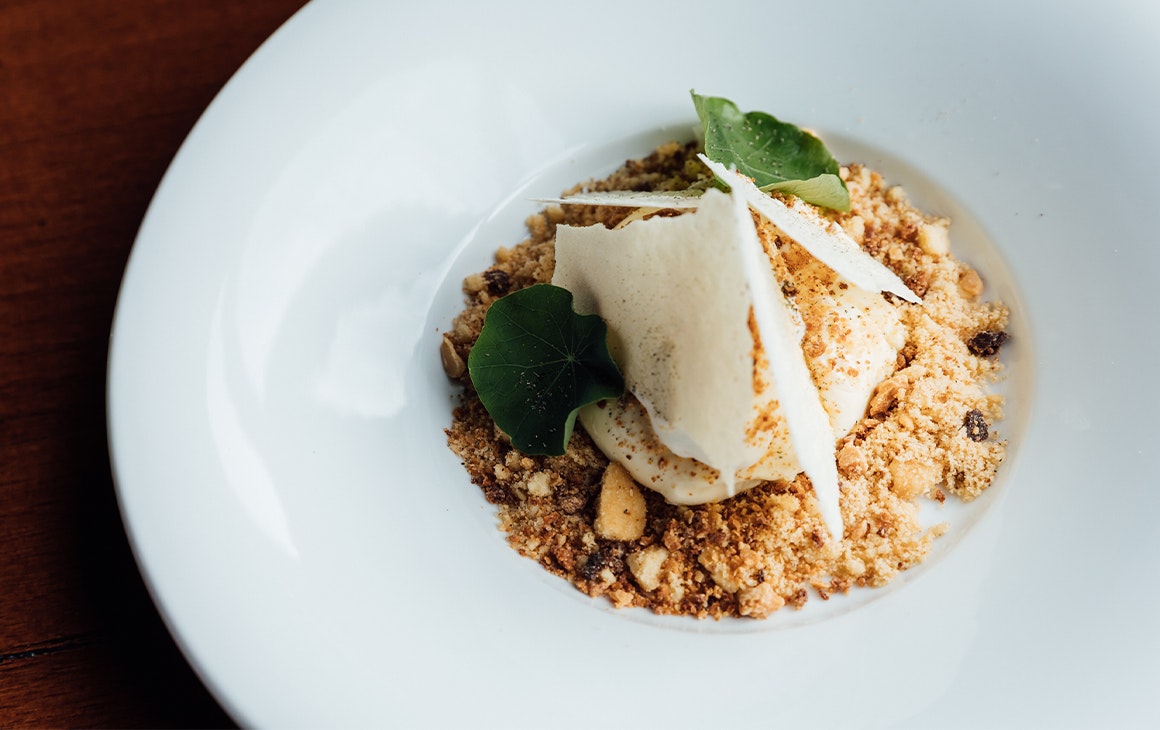 a dessert with crumble and chocolate shards
